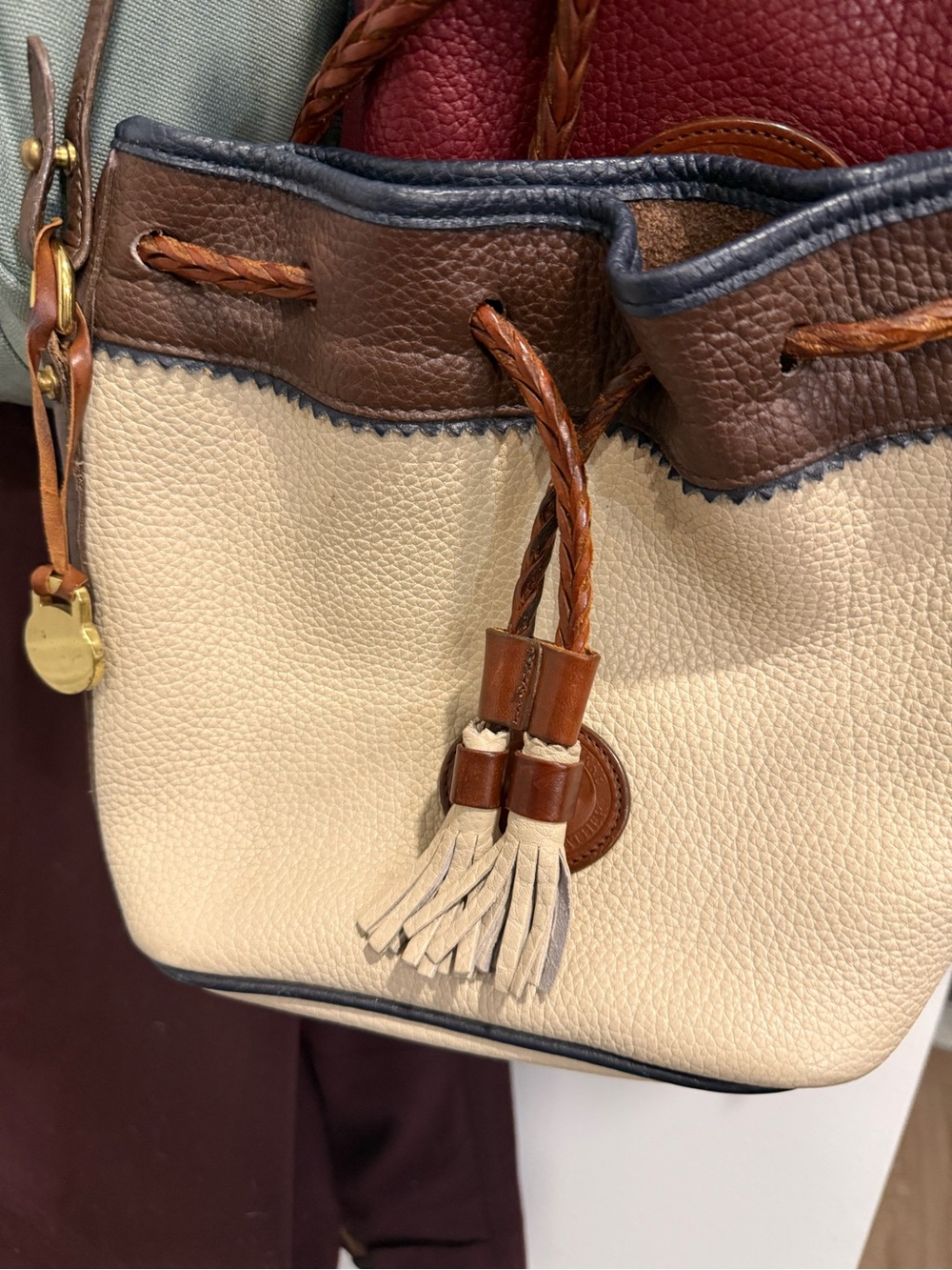 Dooney & Bourke Cream, Brown and Navy Pebbled Leather Drawstring Bucket Bag